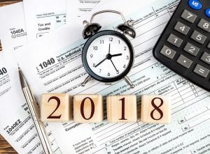 2018 tax season clock and tax form with calculator